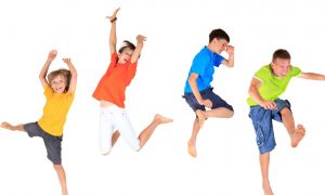 kids jumping in the air in brightly coloured clothes