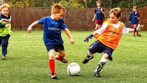 children playing football outdoors