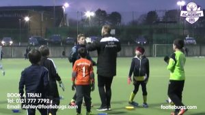 a footiebugs session on an outdoor pitch at night