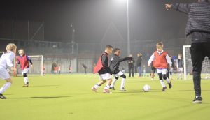 kids kicking a football