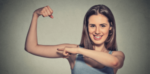 a girl making a muscle and pointing at it