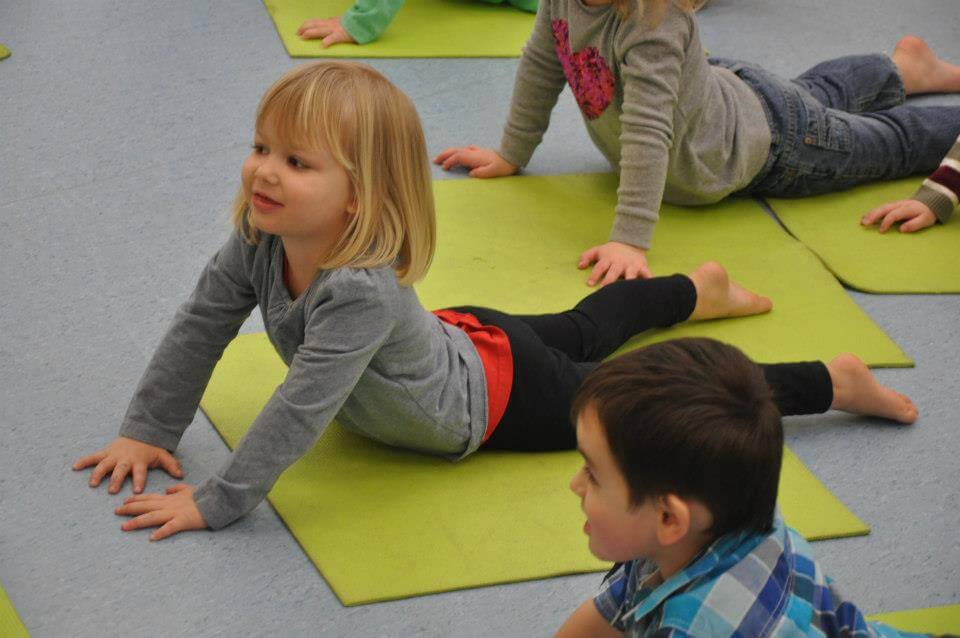 children performing yoga poses