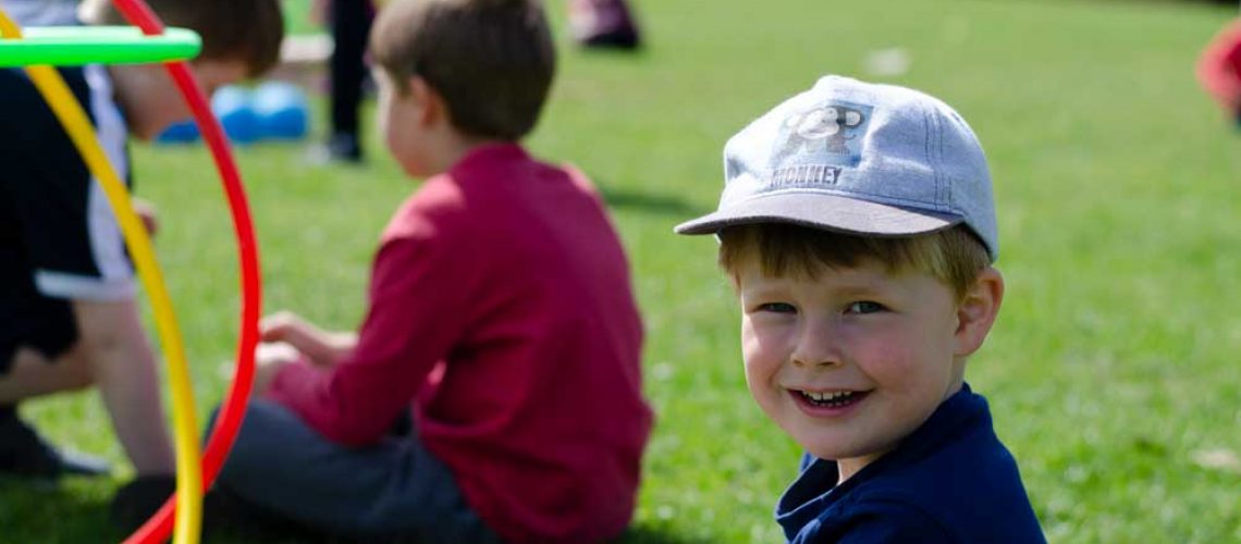 a child smiling outside in the sunshine