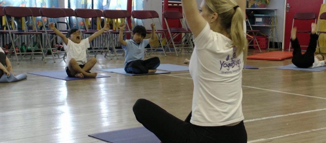 a yogabugs teacher leading a class of children