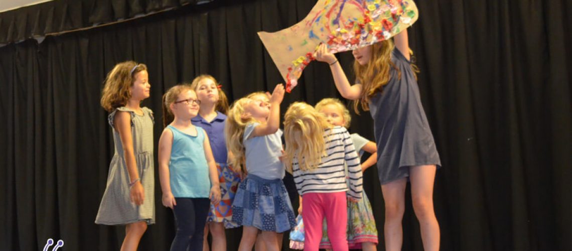 young girls performing in a stage show at dance bugs holiday camp