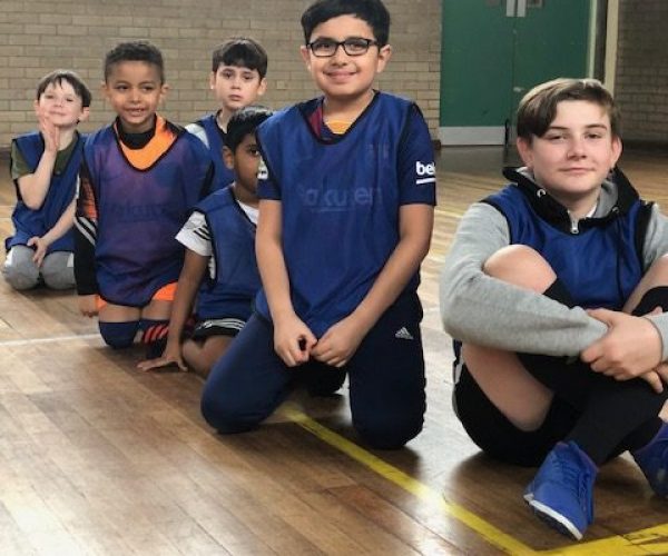 boys sat in a sports hall