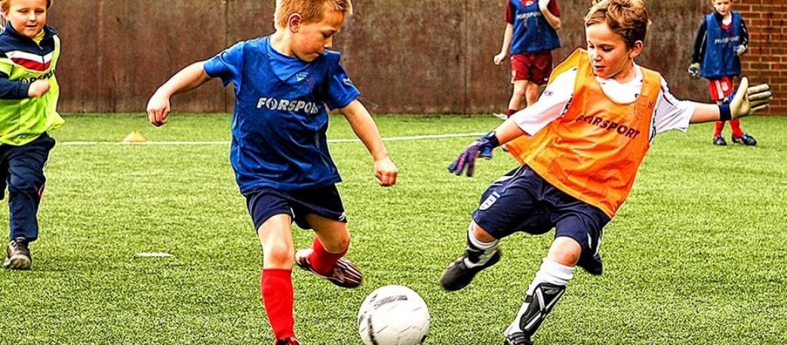 children playing football outdoors