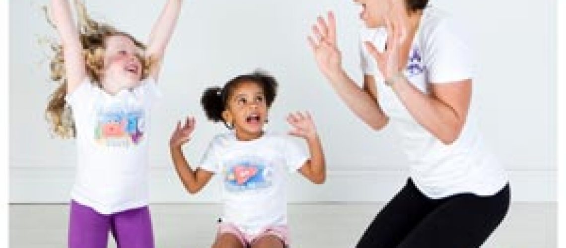 two young children and a yogabugs coach pretending to be lions